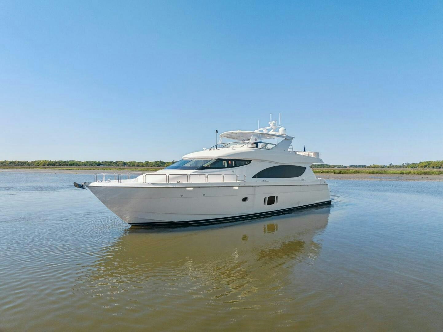a white boat on a river aboard FLYNN'S FOLLY III Yacht for Sale