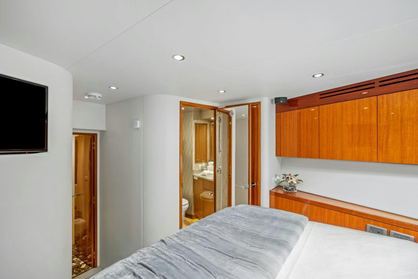 a bedroom with a bed and a television aboard FLYNN'S FOLLY III Yacht for Sale