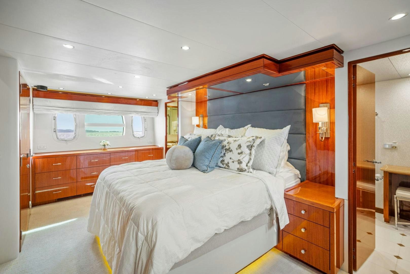 a bedroom with a bed and a dresser aboard FLYNN'S FOLLY III Yacht for Sale