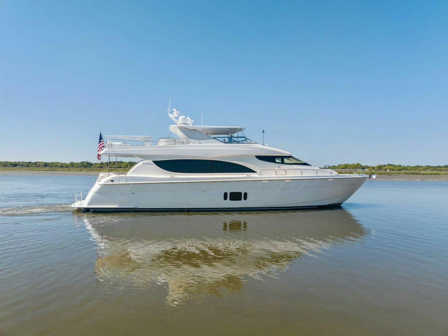a white boat on a lake aboard FLYNN'S FOLLY III Yacht for Sale