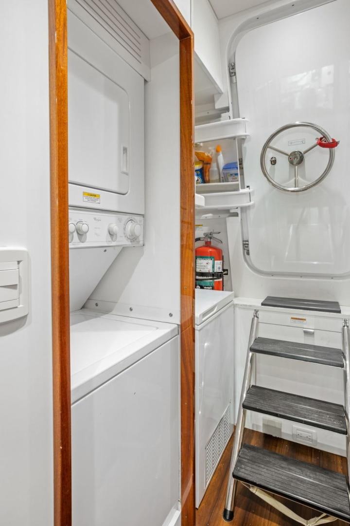 a white kitchen with a white wall aboard FLYNN'S FOLLY III Yacht for Sale