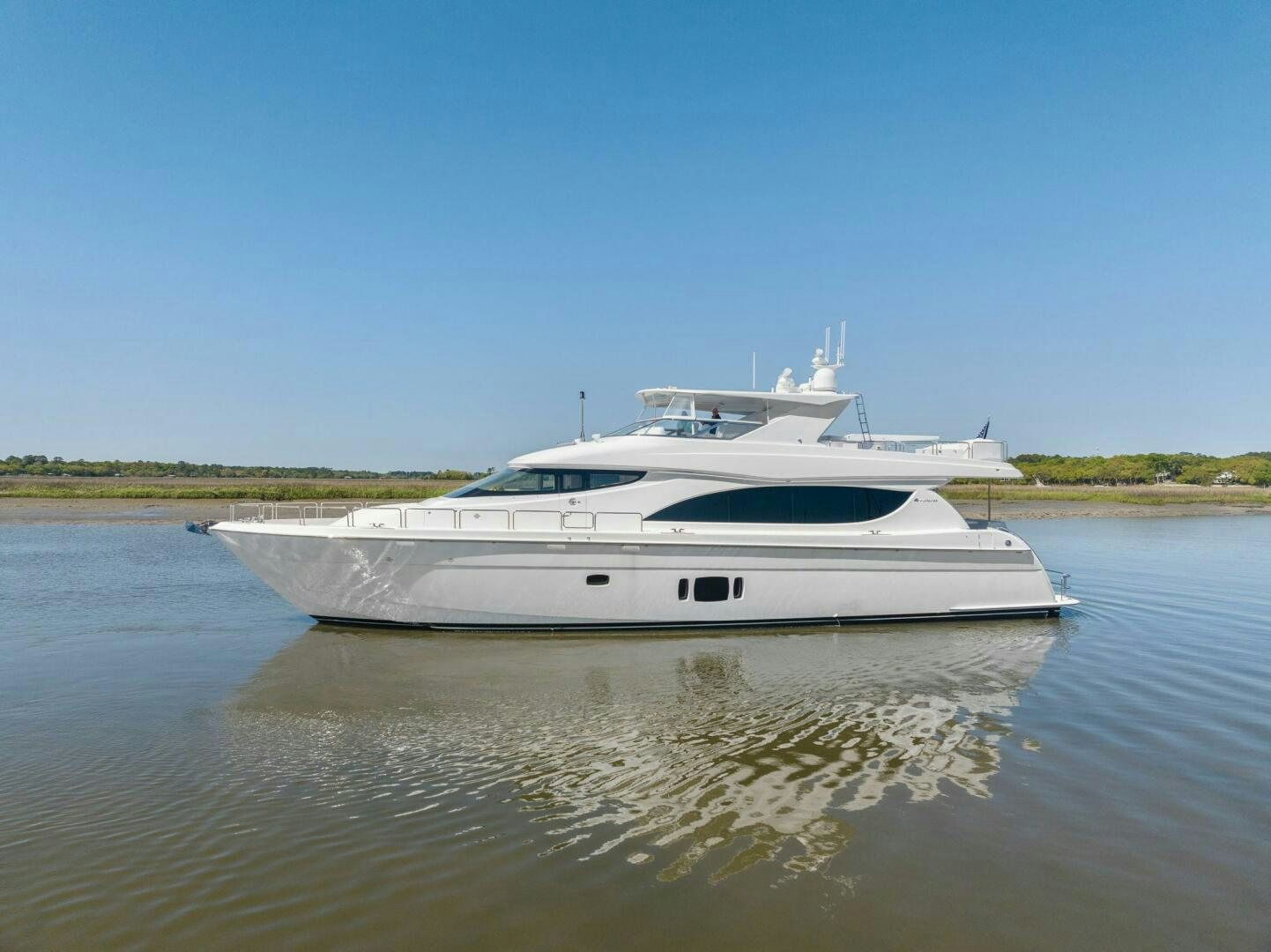 a white boat on a river aboard FLYNN'S FOLLY III Yacht for Sale