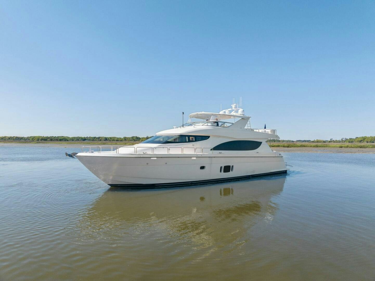 a white boat on a river aboard FLYNN'S FOLLY III Yacht for Sale
