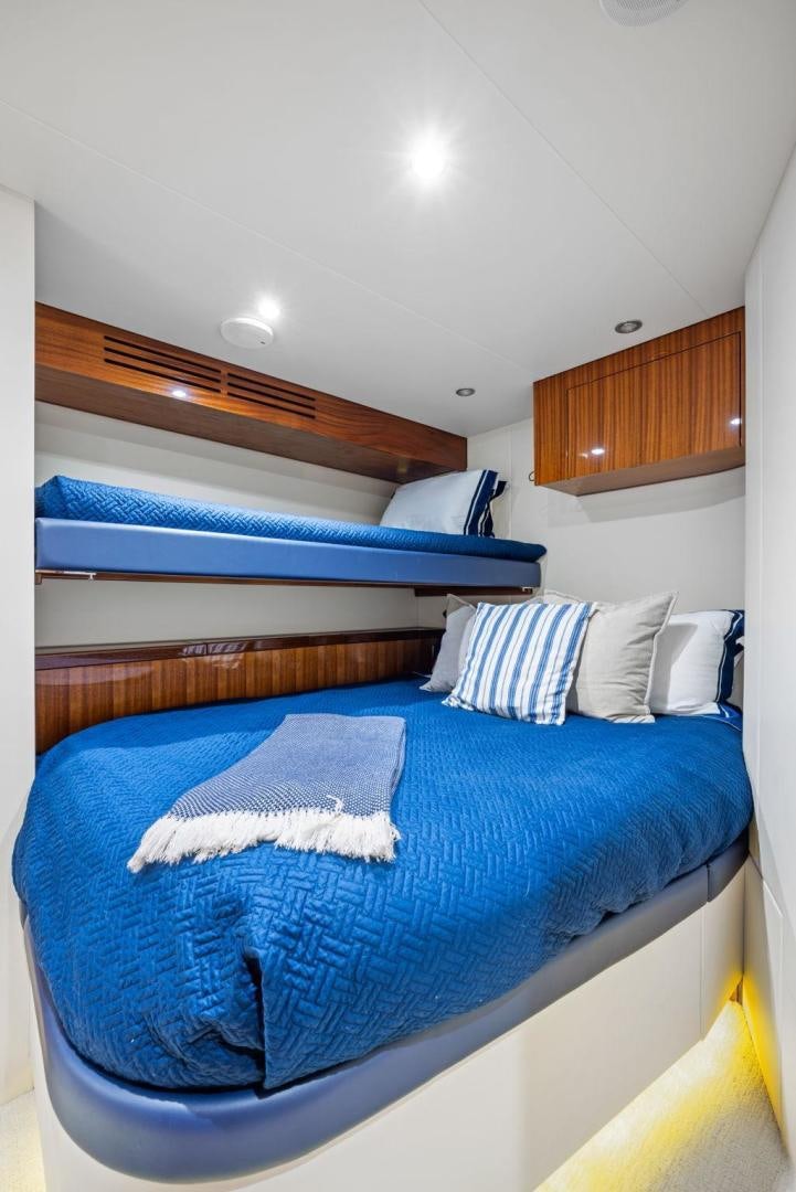 a bed with blue sheets aboard FLYNN'S FOLLY III Yacht for Sale