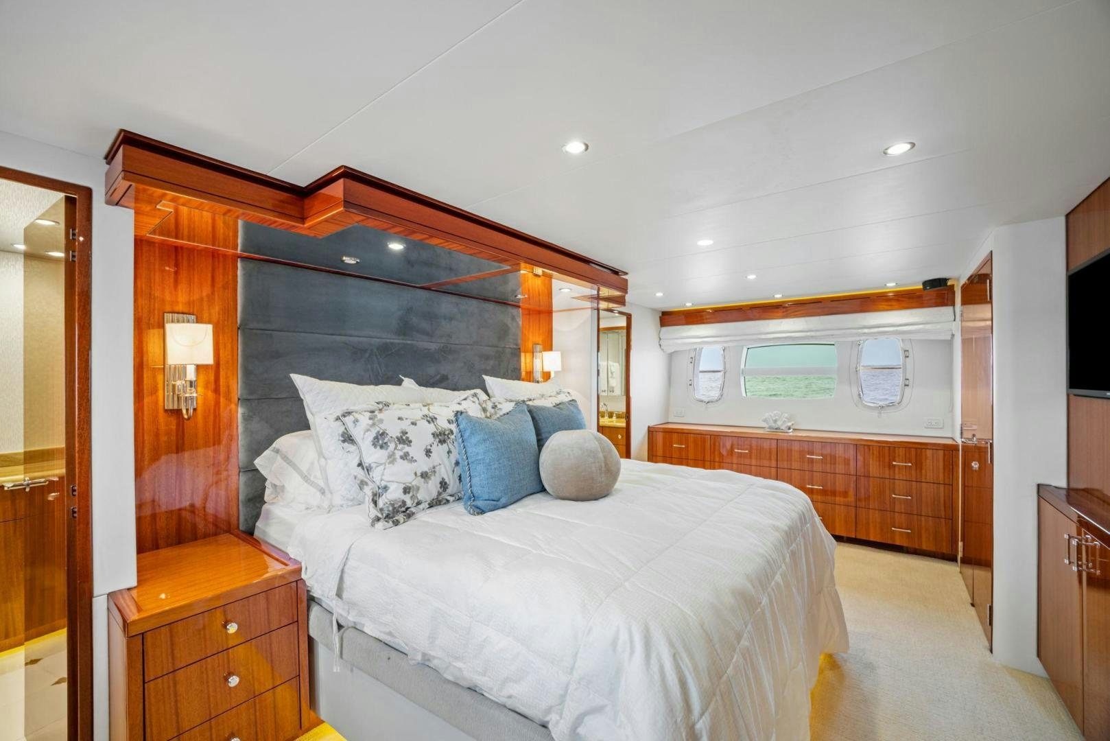 a bedroom with a bed and a dresser aboard FLYNN'S FOLLY III Yacht for Sale