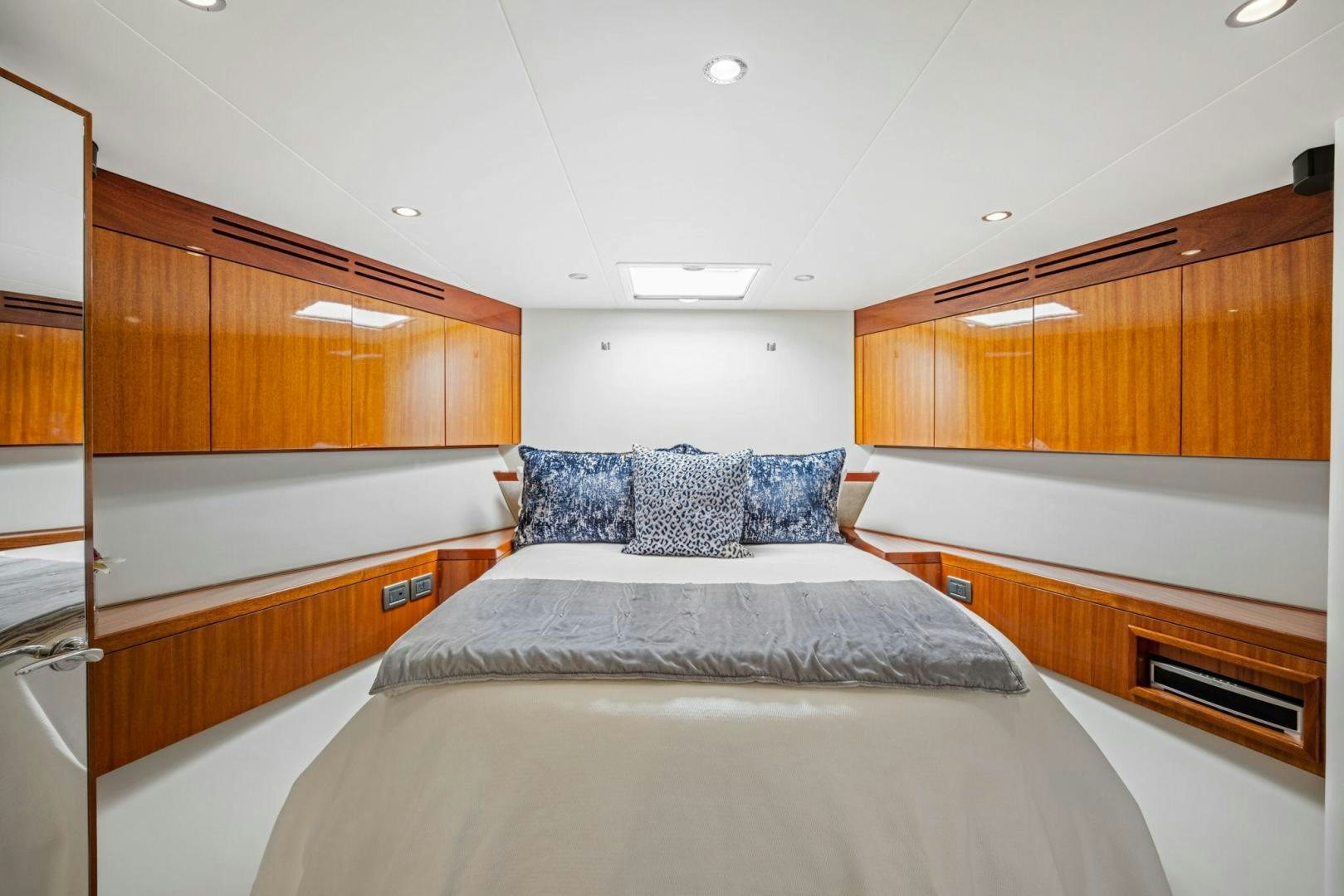 a large bedroom with wooden cabinets aboard FLYNN'S FOLLY III Yacht for Sale
