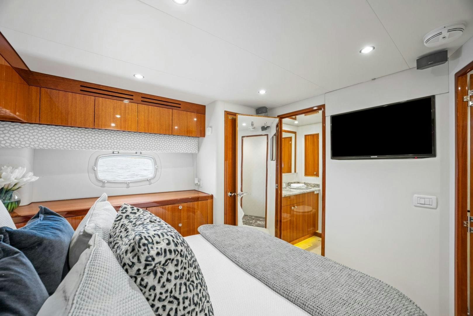 a bedroom with a bed and a television aboard FLYNN'S FOLLY III Yacht for Sale