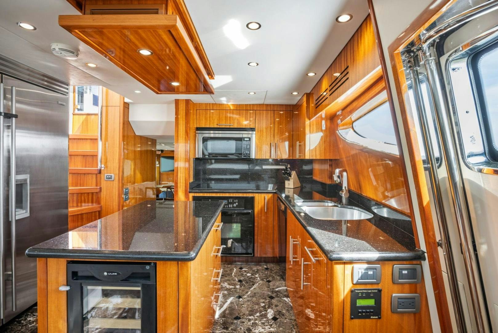 a kitchen with wooden cabinets aboard FLYNN'S FOLLY III Yacht for Sale