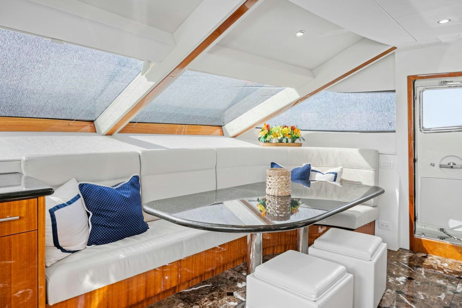 a white couch with a table and a coffee table aboard FLYNN'S FOLLY III Yacht for Sale