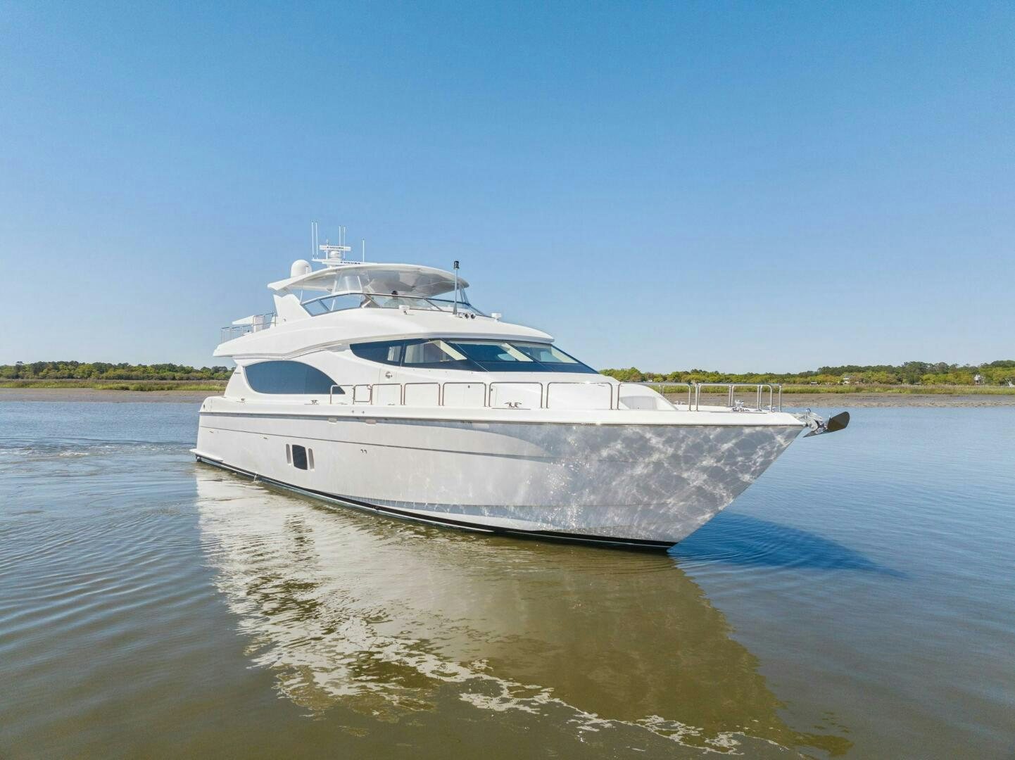 a white boat on a river aboard FLYNN'S FOLLY III Yacht for Sale