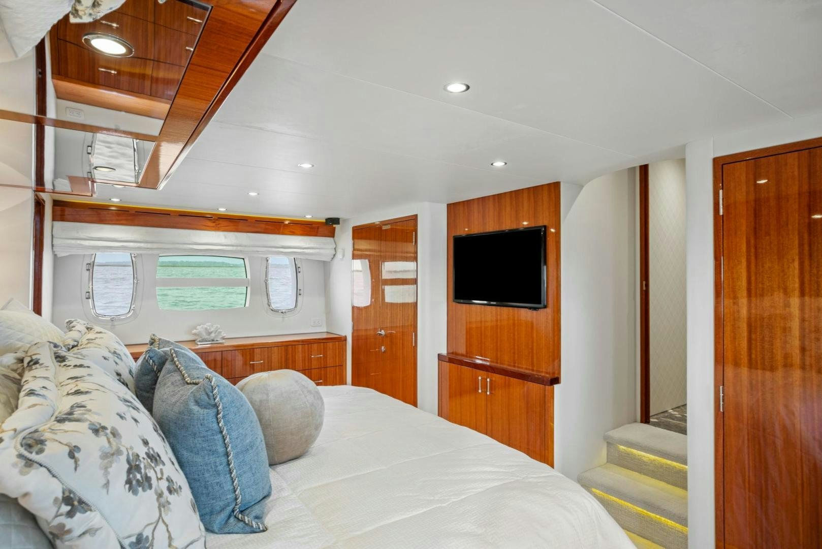 a bedroom with a bed and a television aboard FLYNN'S FOLLY III Yacht for Sale