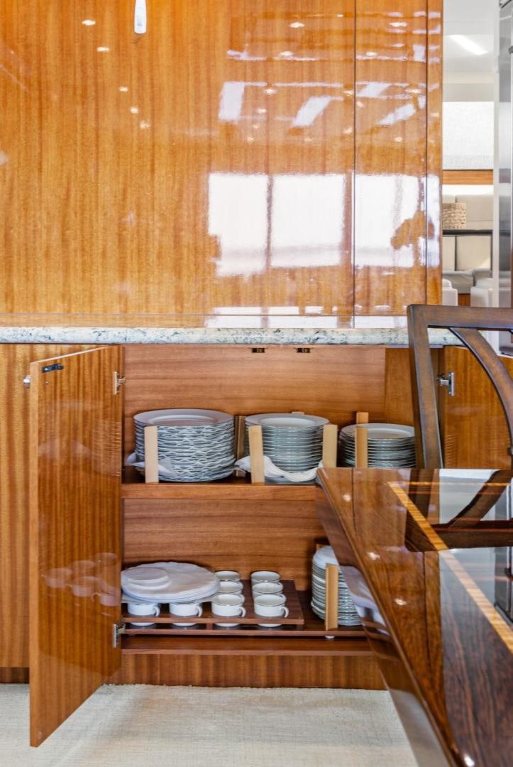 a wooden cabinet with plates and bowls on it aboard FLYNN'S FOLLY III Yacht for Sale