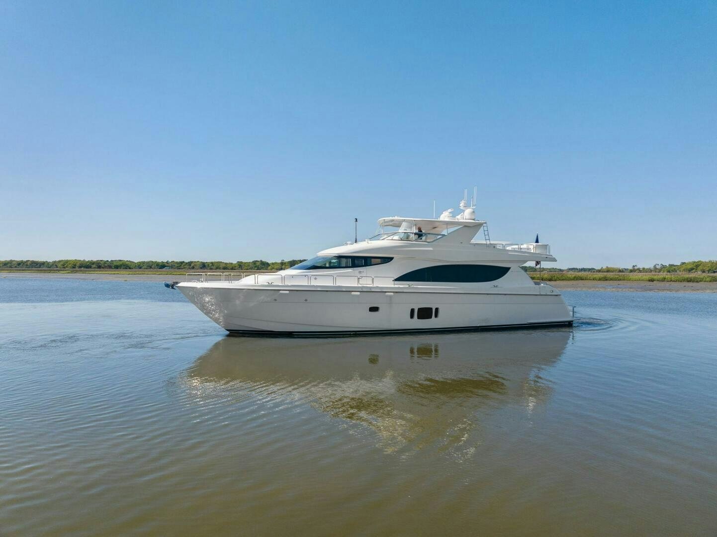 a white boat on a river aboard FLYNN'S FOLLY III Yacht for Sale
