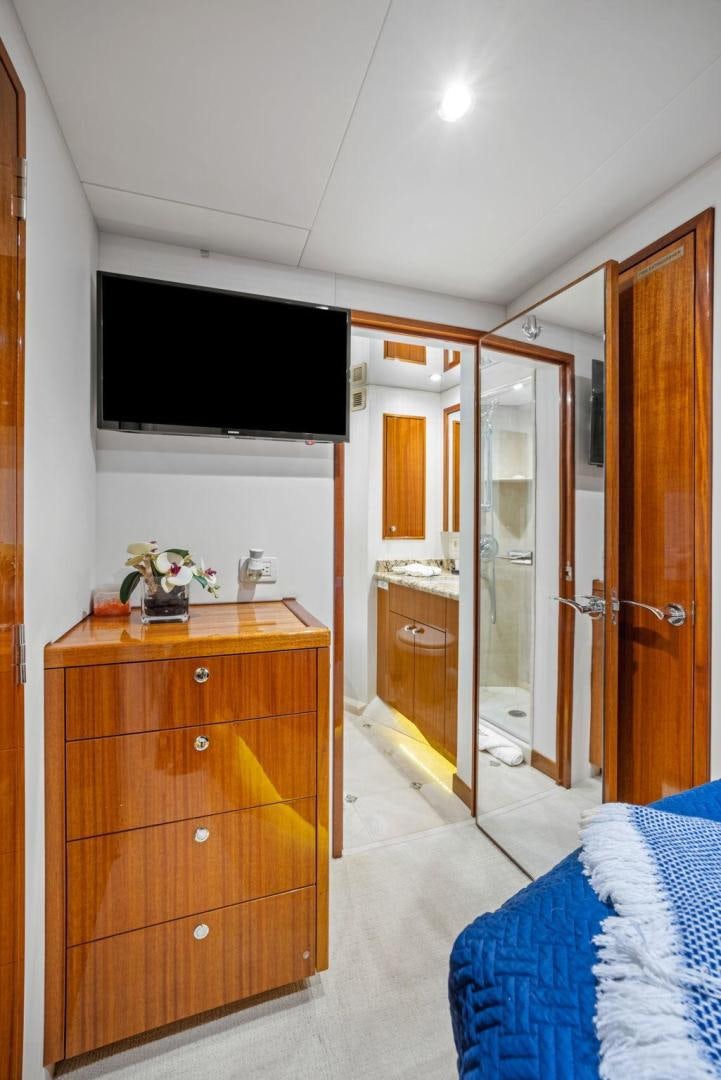 a bedroom with a tv and a dresser aboard FLYNN'S FOLLY III Yacht for Sale