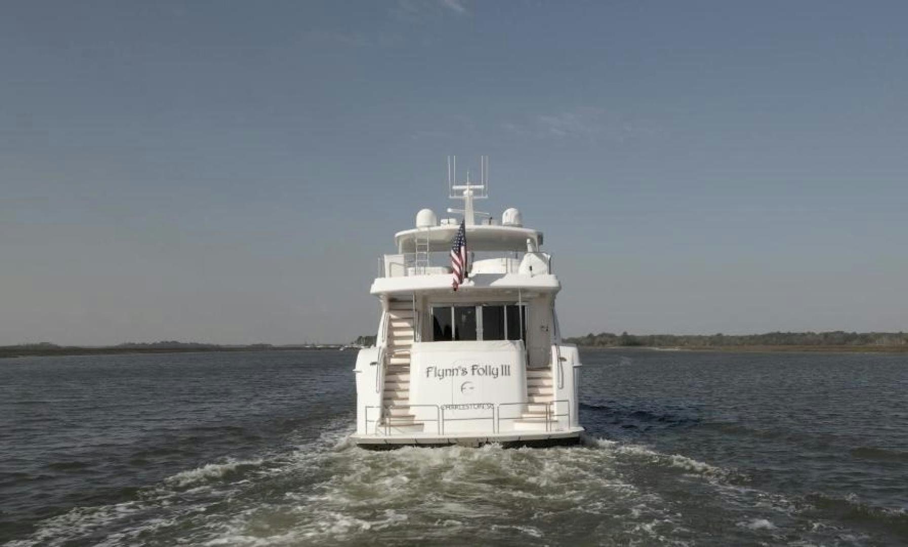 a small white boat in the water aboard FLYNN'S FOLLY III Yacht for Sale