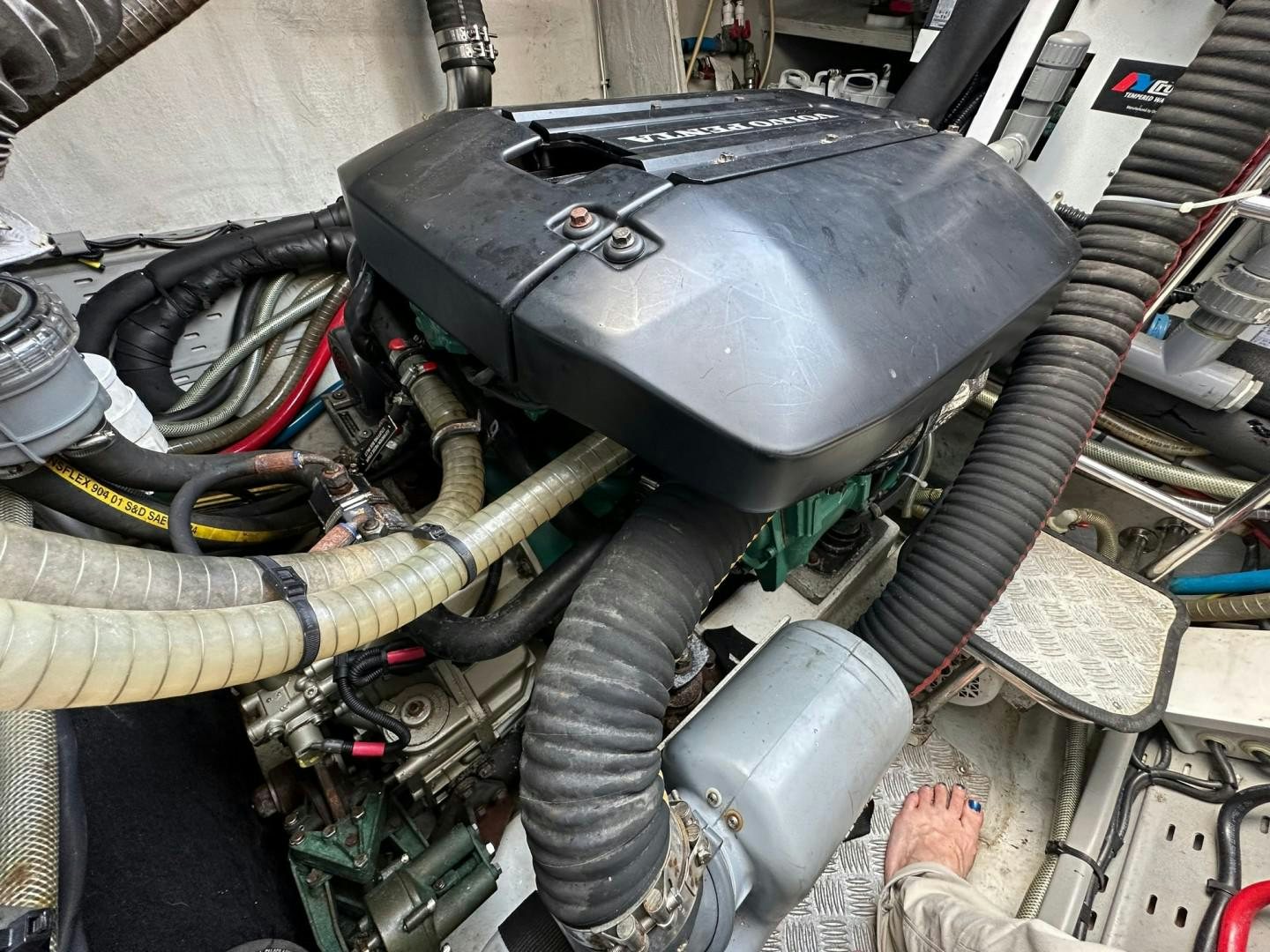 a car engine with a person standing next to it aboard OCEAN VIEW Yacht for Sale