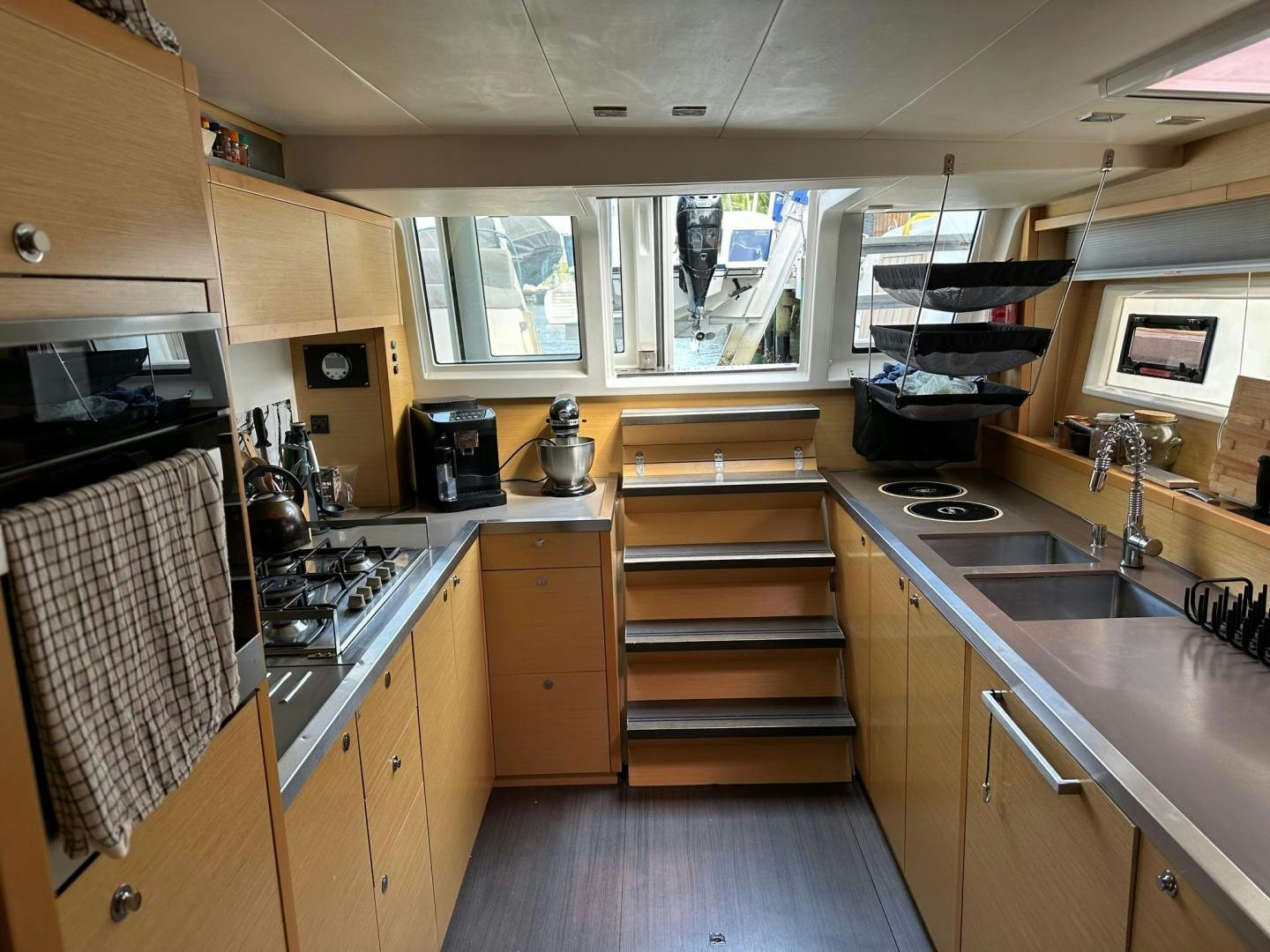 a kitchen with wooden cabinets aboard OCEAN VIEW Yacht for Sale