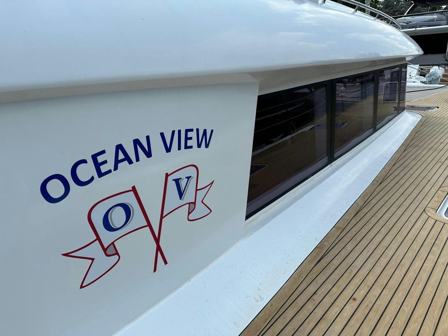 a large white sign with a red and blue logo on it aboard OCEAN VIEW Yacht for Sale