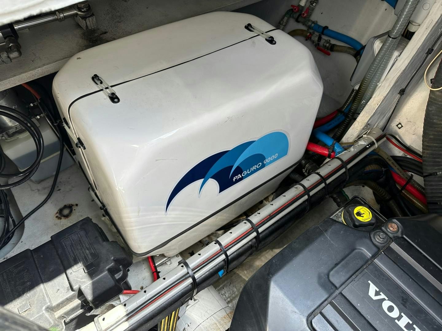 a white machine with a blue logo aboard OCEAN VIEW Yacht for Sale