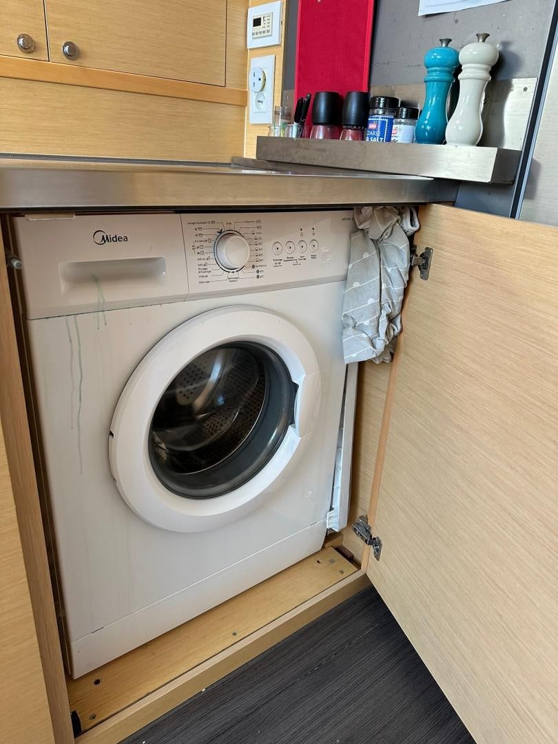 a washing machine in a kitchen aboard OCEAN VIEW Yacht for Sale