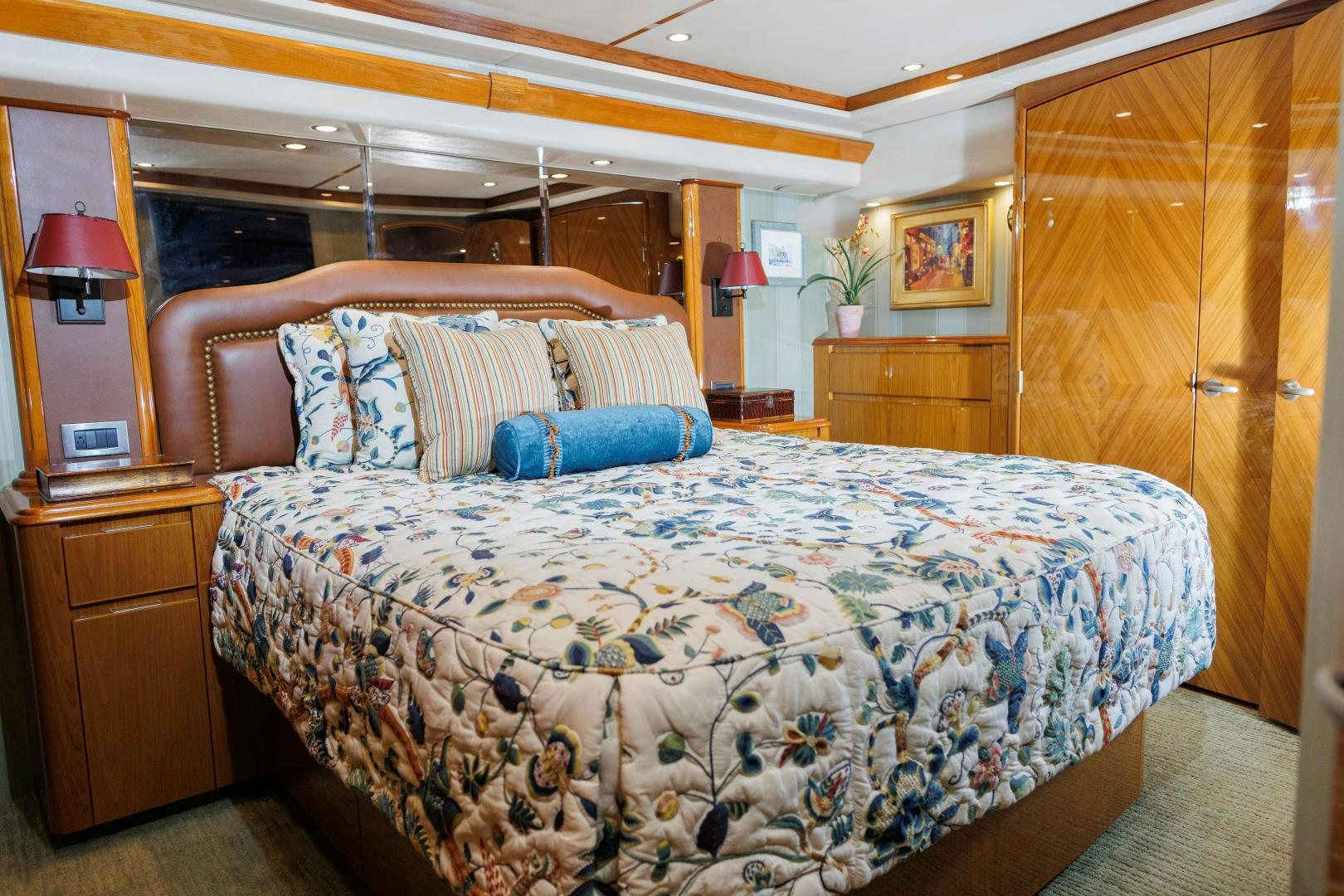 a bed with a blue and white comforter and pillows aboard MOONDANCER Yacht for Sale