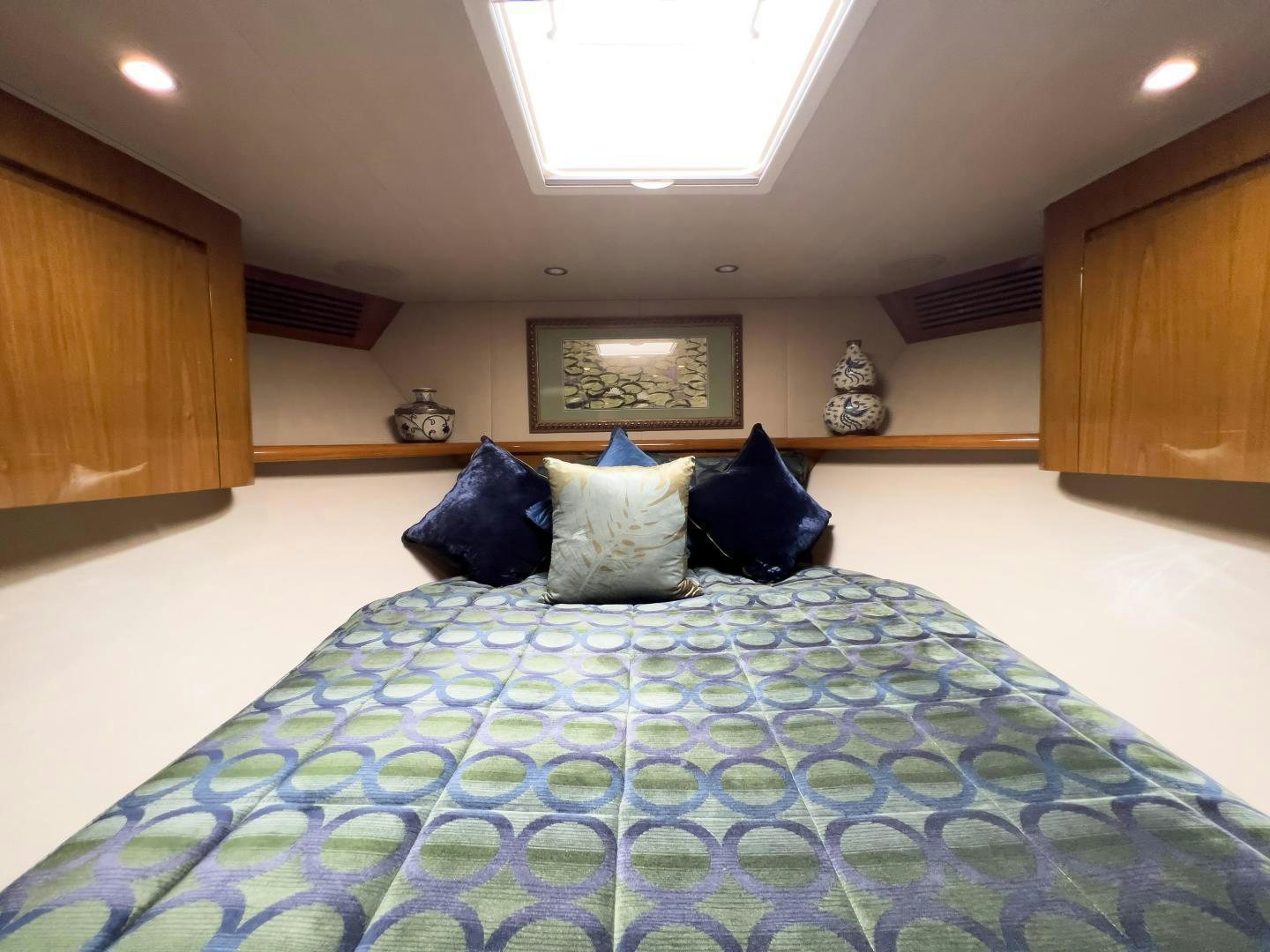 a bed with blue pillows aboard MOONDANCER Yacht for Sale