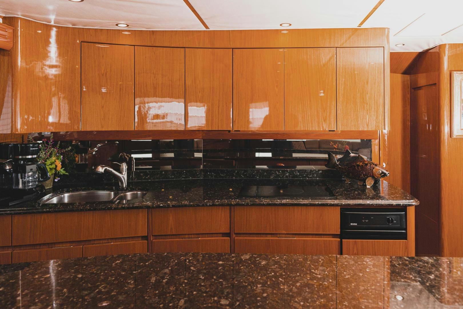 a kitchen with wooden cabinets aboard MOONDANCER Yacht for Sale