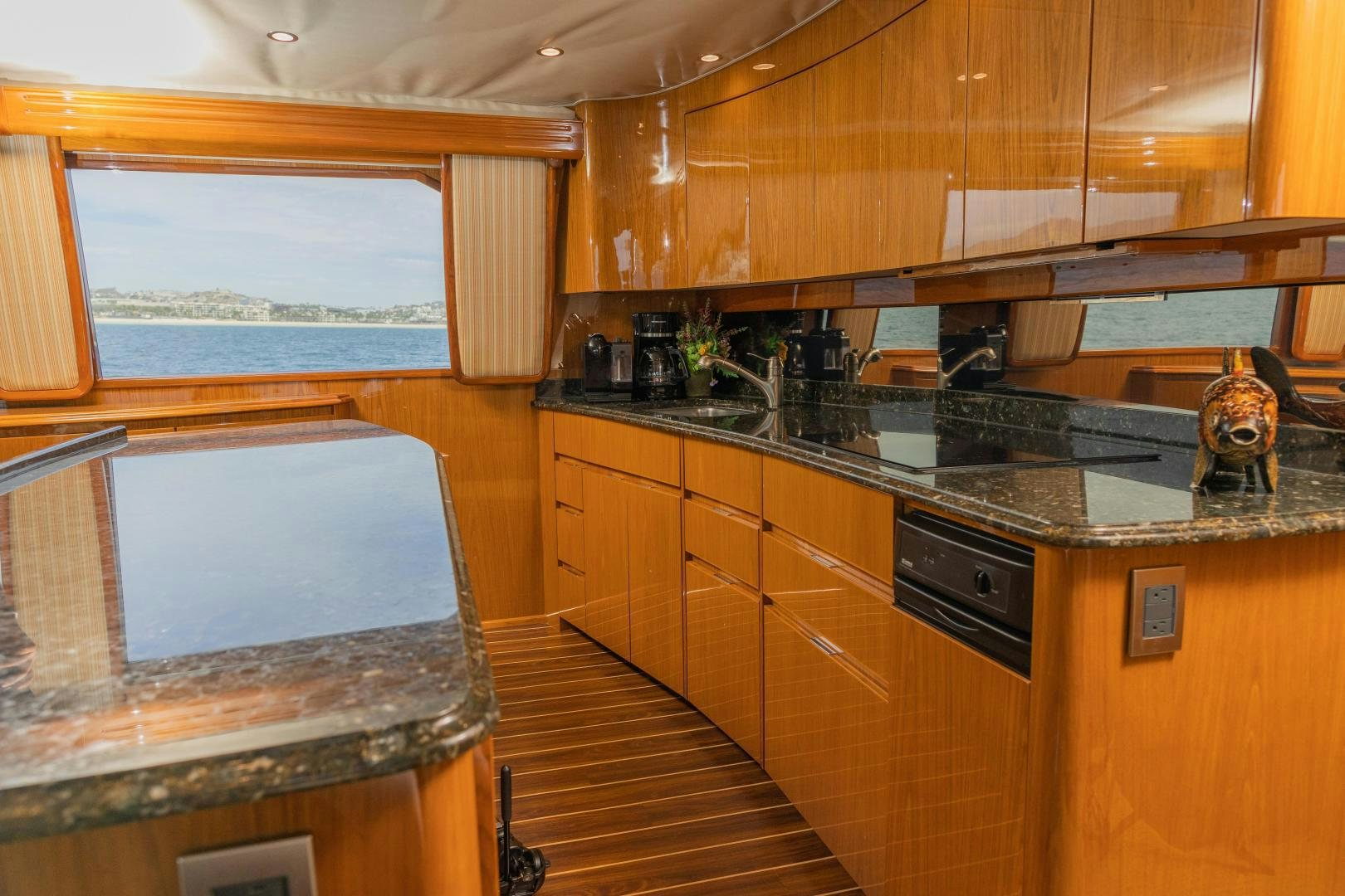 a kitchen with wooden cabinets aboard MOONDANCER Yacht for Sale