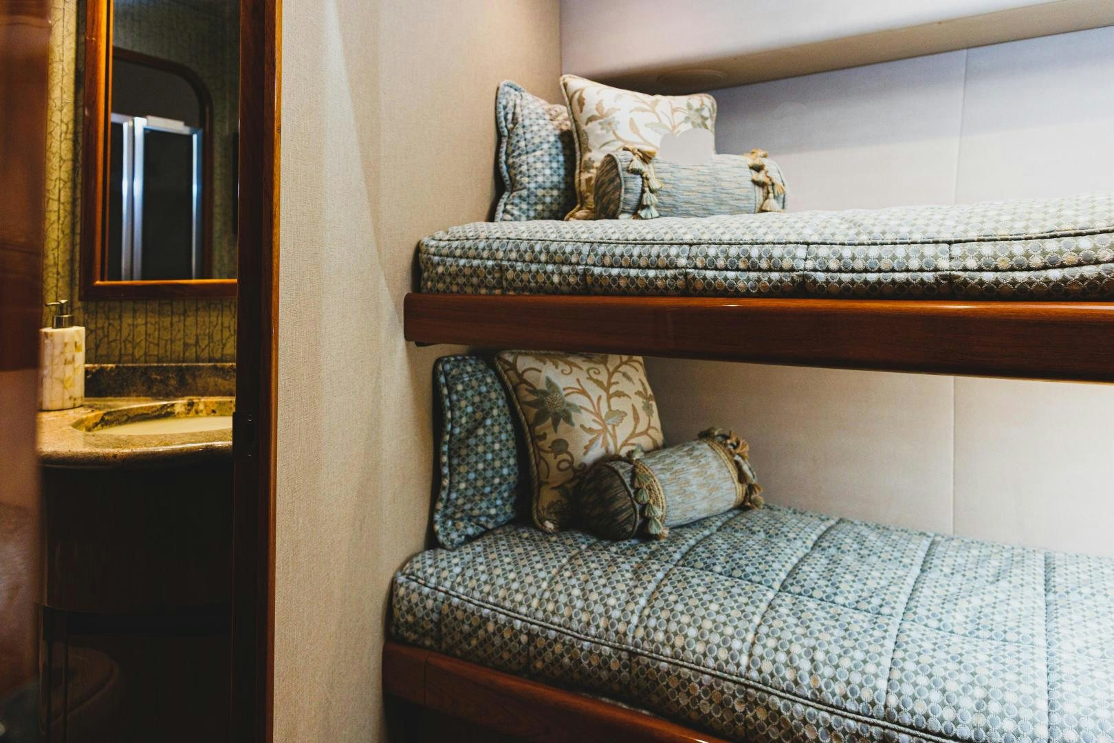 a bed with a blue blanket aboard MOONDANCER Yacht for Sale