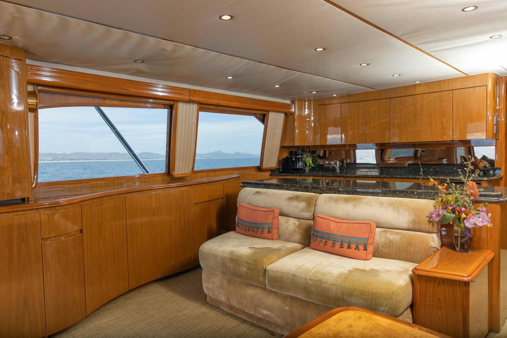 a large kitchen with wooden cabinets aboard MOONDANCER Yacht for Sale