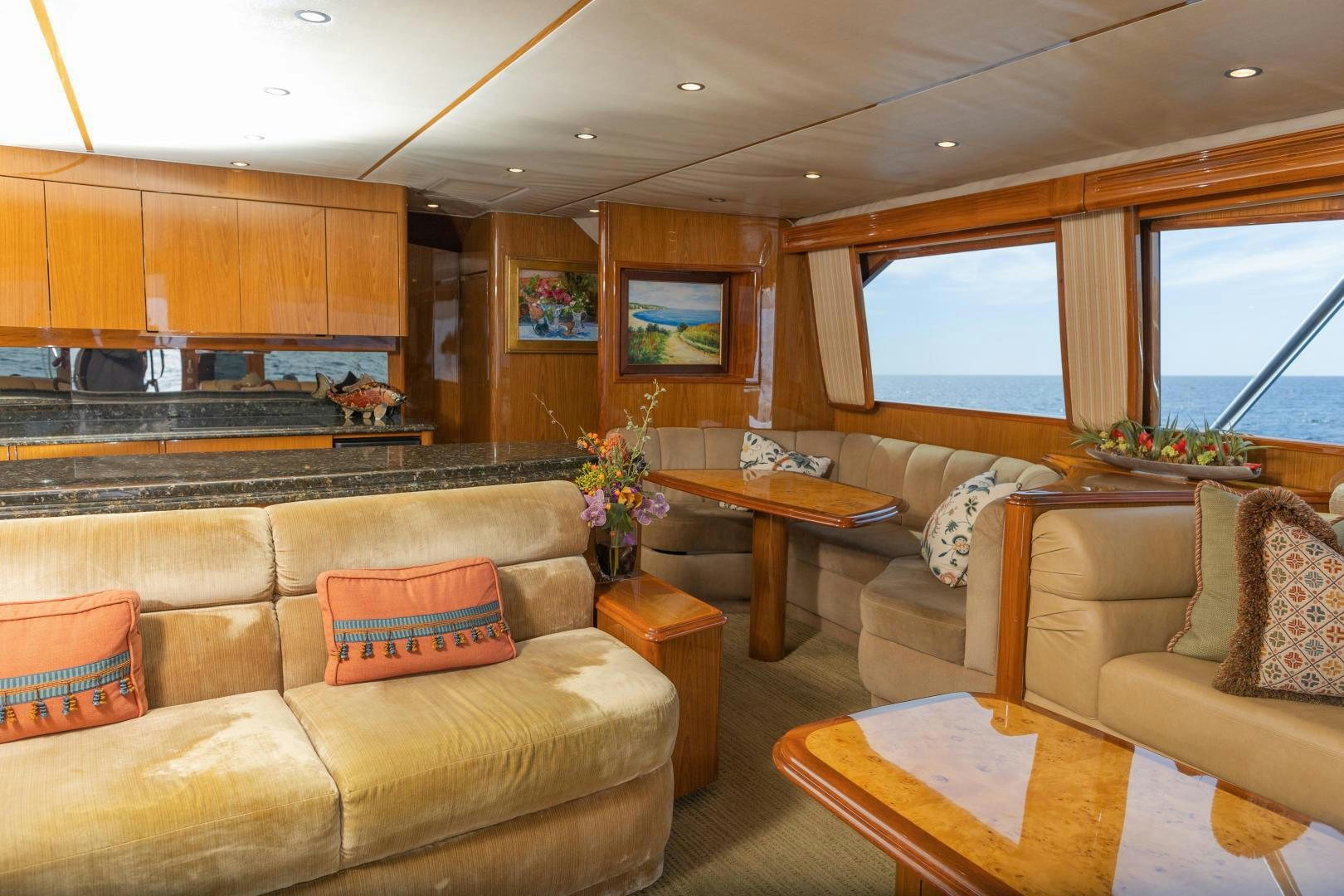 a living room with a large kitchen aboard MOONDANCER Yacht for Sale
