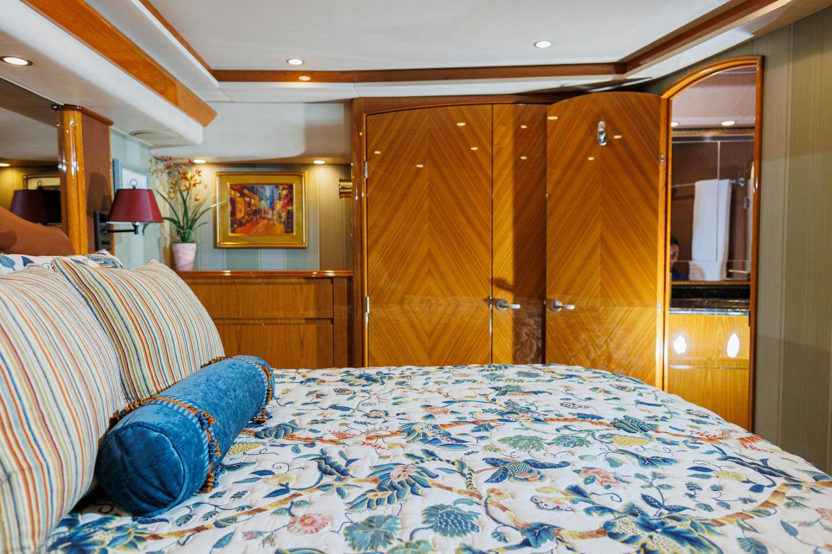 a bed with a blue and white checkered blanket aboard MOONDANCER Yacht for Sale