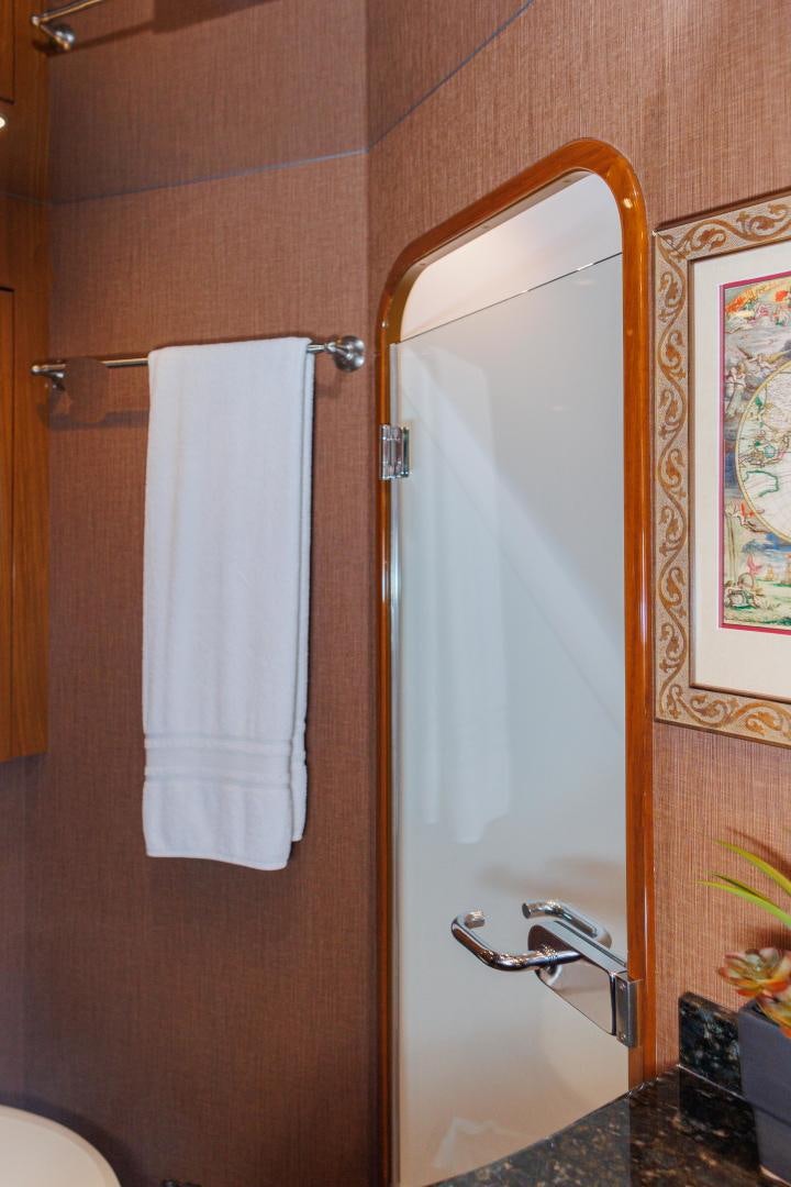 a bathroom with a mirror and a towel on the wall aboard MOONDANCER Yacht for Sale