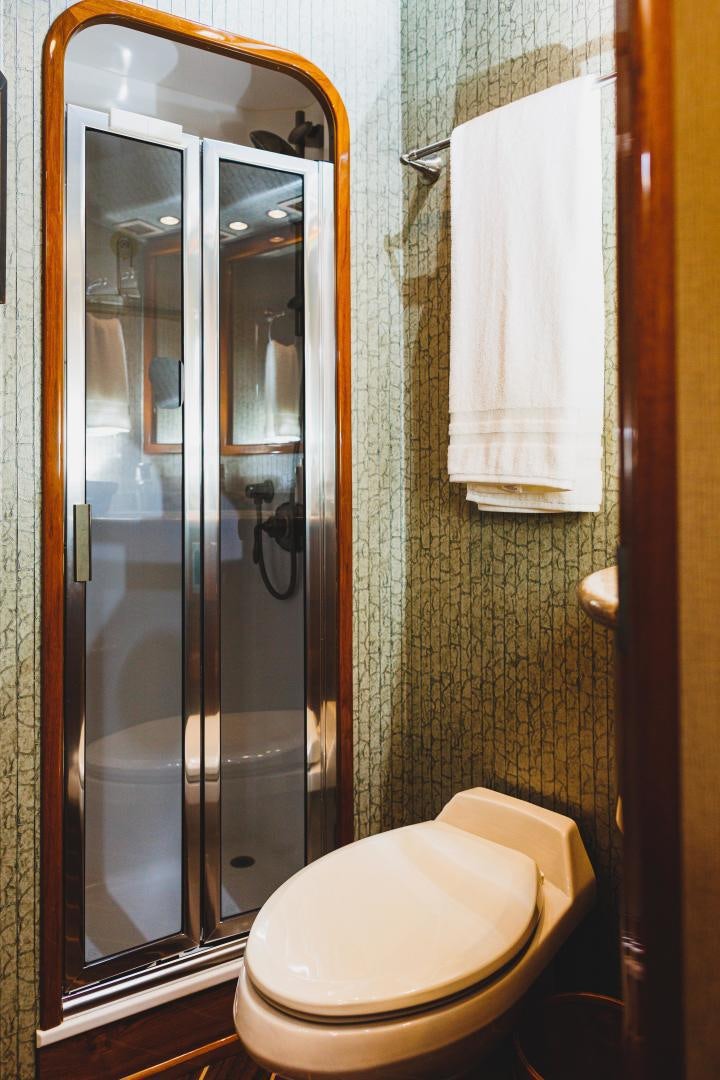 a bathroom with a glass shower door aboard MOONDANCER Yacht for Sale