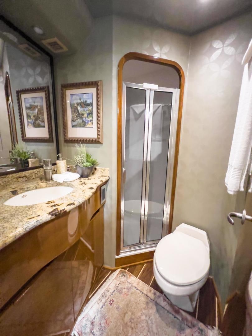 a bathroom with a glass shower door aboard MOONDANCER Yacht for Sale