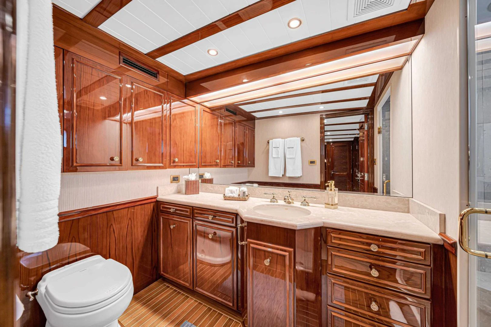 a bathroom with wooden cabinets aboard INEVITABLE Yacht for Sale