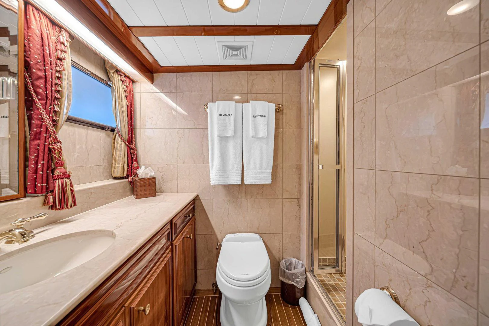 a bathroom with a toilet sink and a mirror aboard INEVITABLE Yacht for Sale