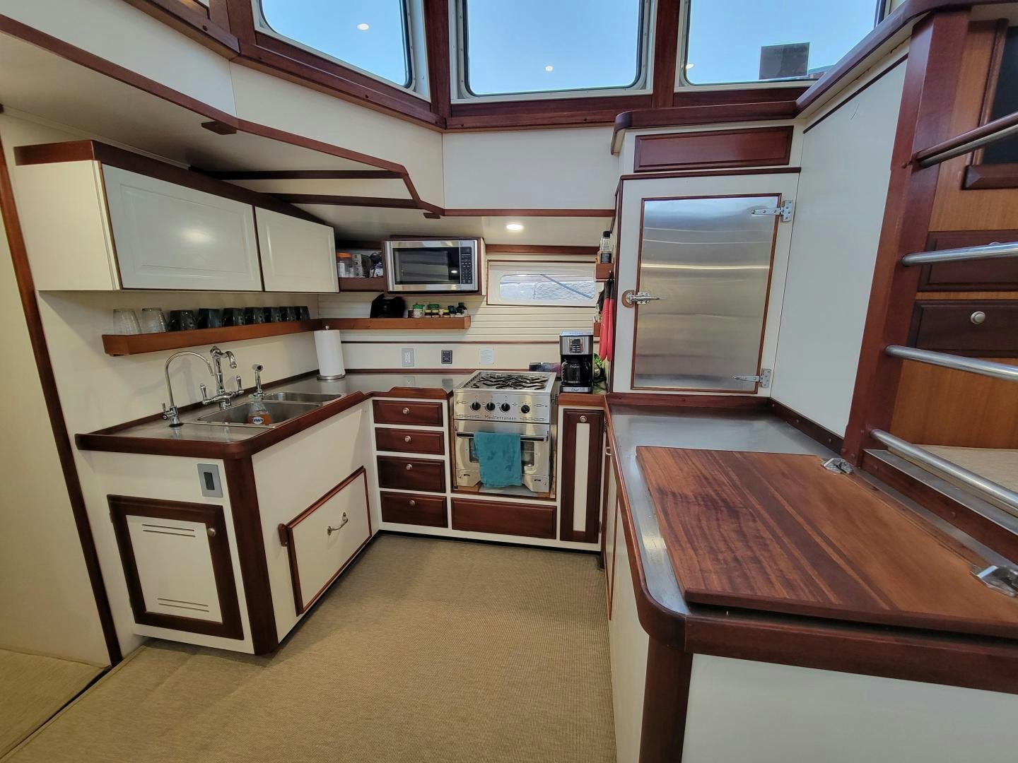a kitchen with a table and microwave aboard TARA Yacht for Sale