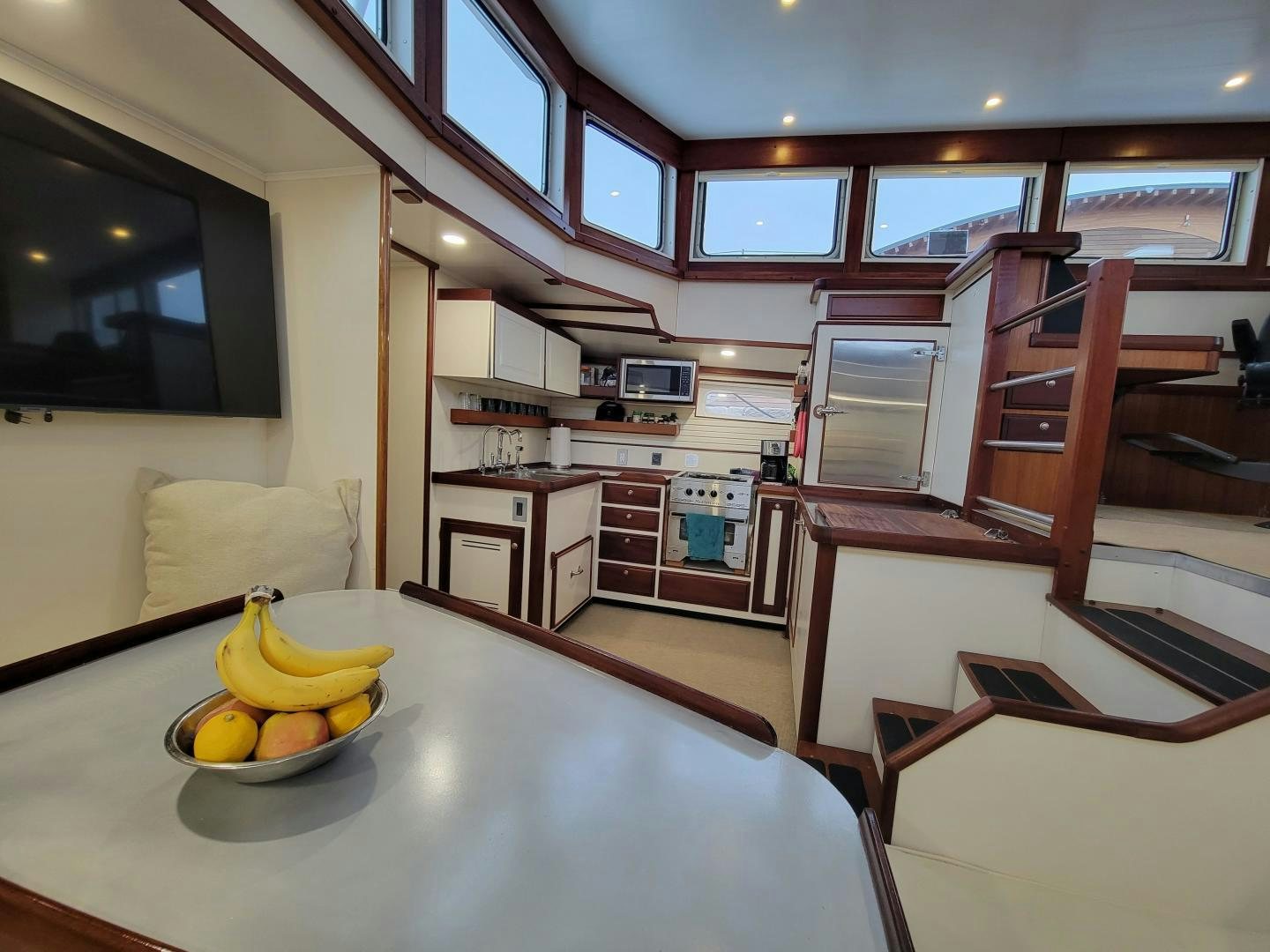 a kitchen with a table and chairs aboard TARA Yacht for Sale