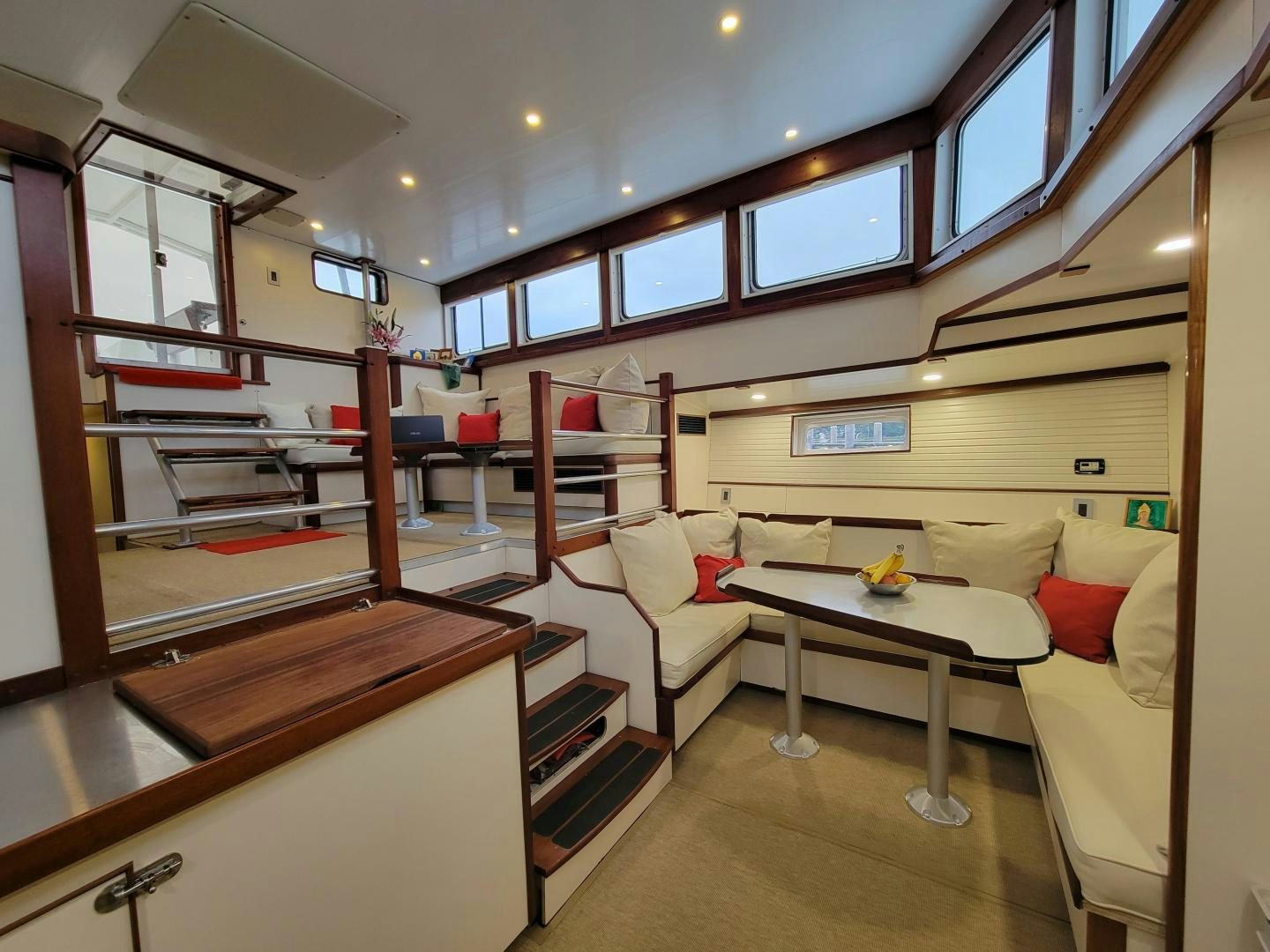 a room with a table and couch aboard TARA Yacht for Sale