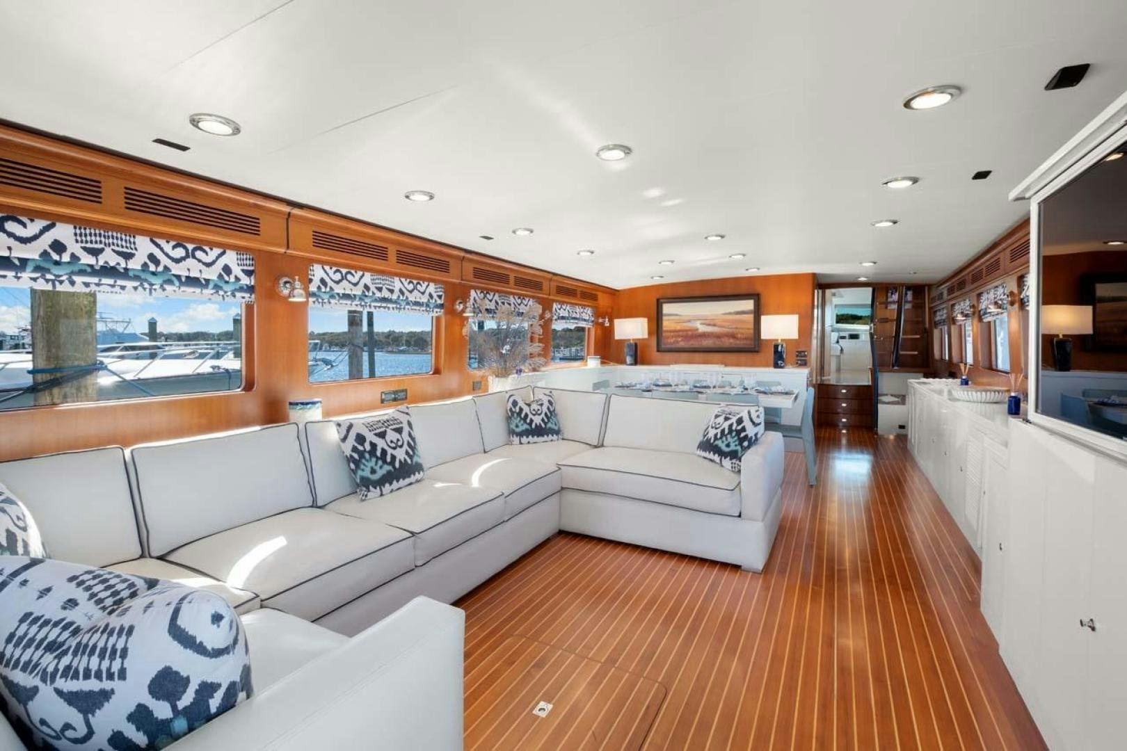 a living room with a large sofa aboard PIVOT Yacht for Sale