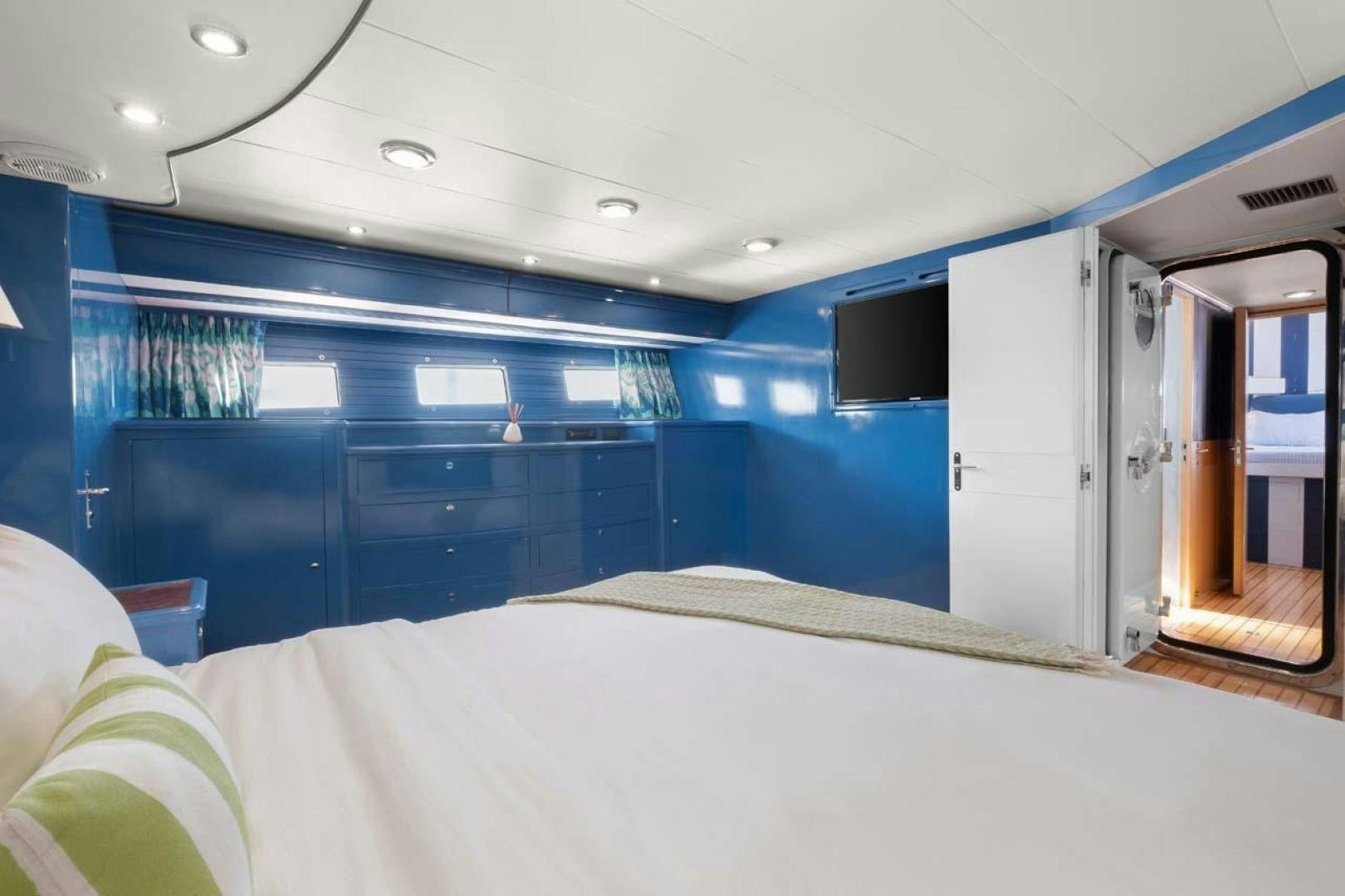 a room with a bed and a door aboard PIVOT Yacht for Sale
