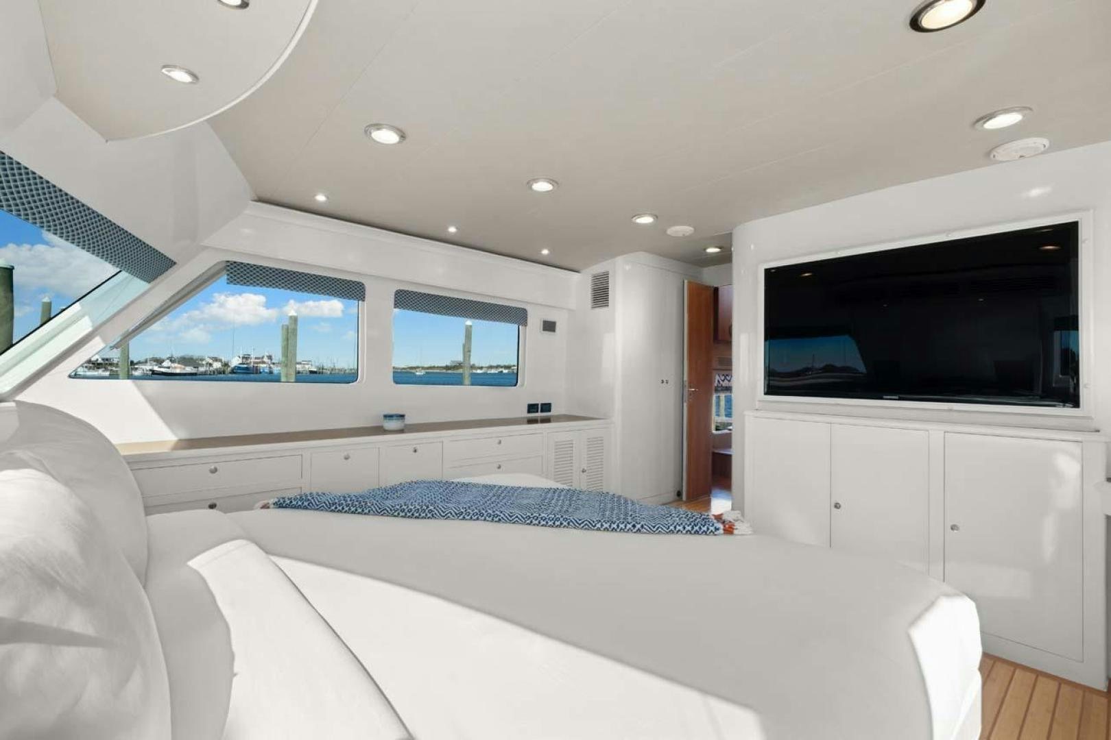 a bedroom with a large tv aboard PIVOT Yacht for Sale