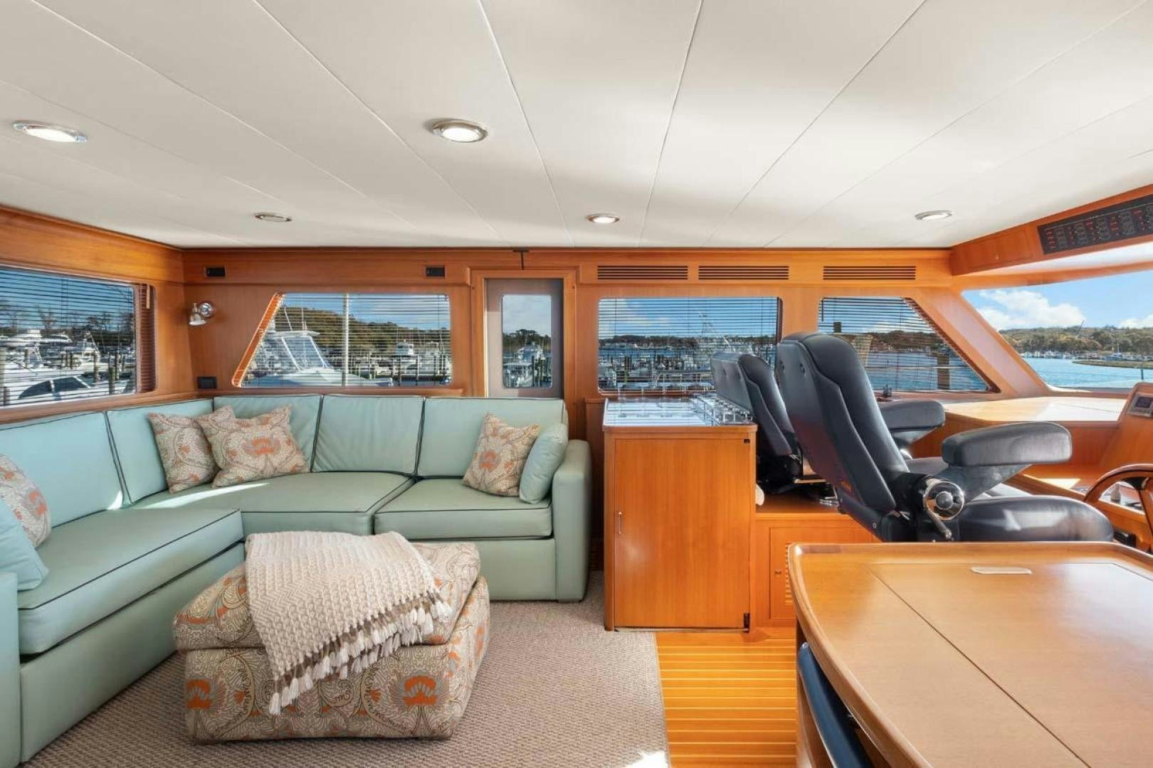 a living room with a couch and a table aboard PIVOT Yacht for Sale