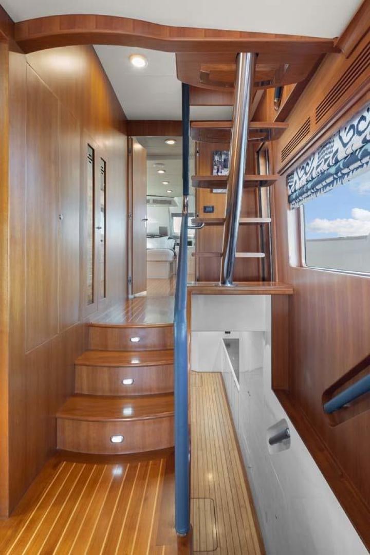 a wooden staircase in a house aboard PIVOT Yacht for Sale