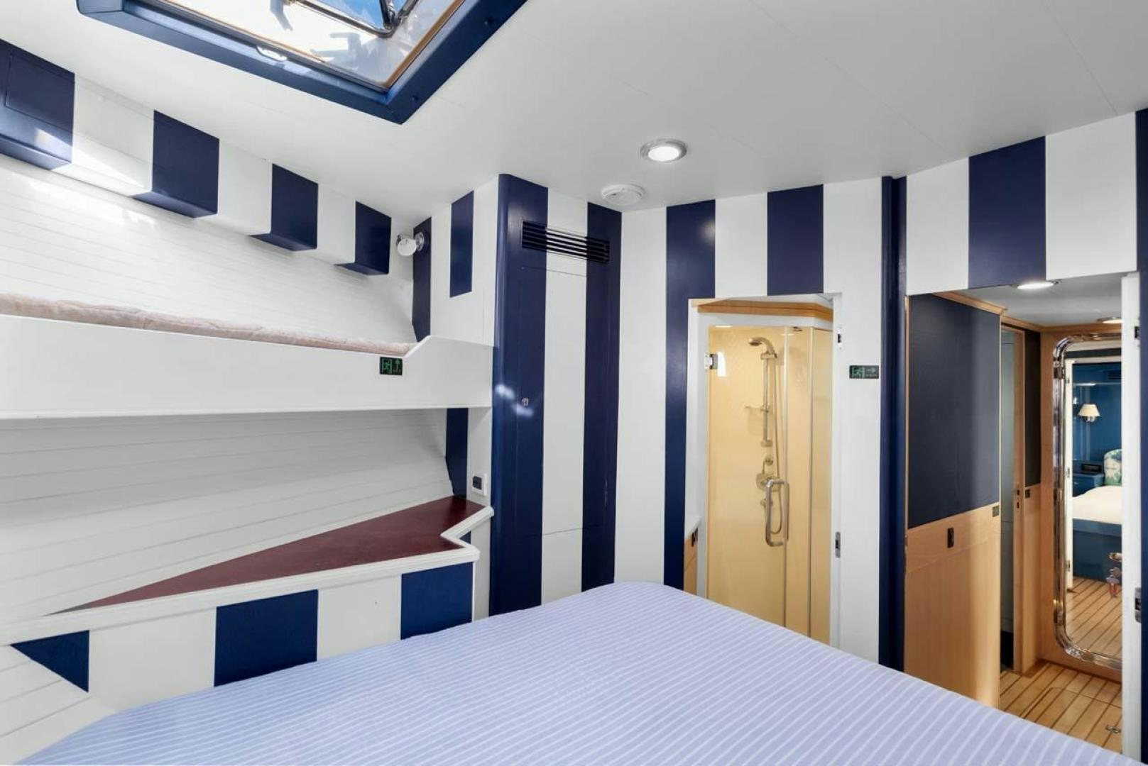 a room with a bed and a door aboard PIVOT Yacht for Sale