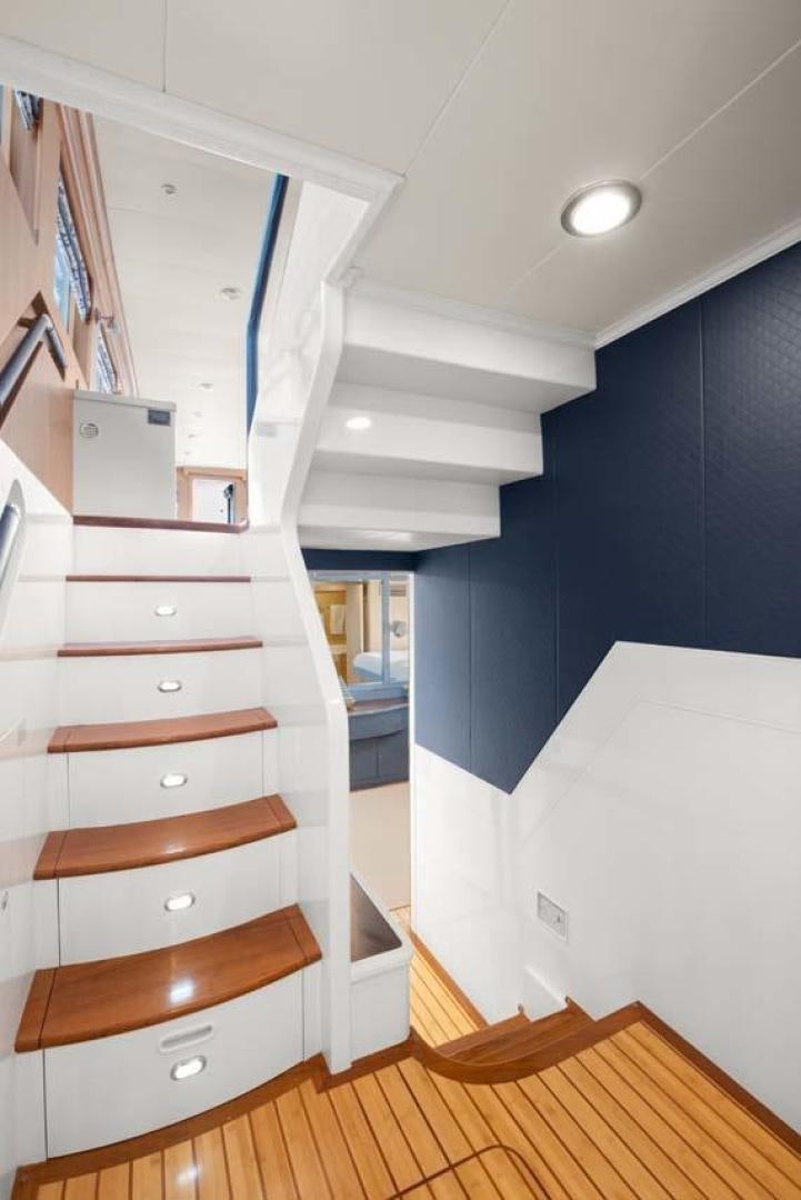 a wooden staircase in a room aboard PIVOT Yacht for Sale