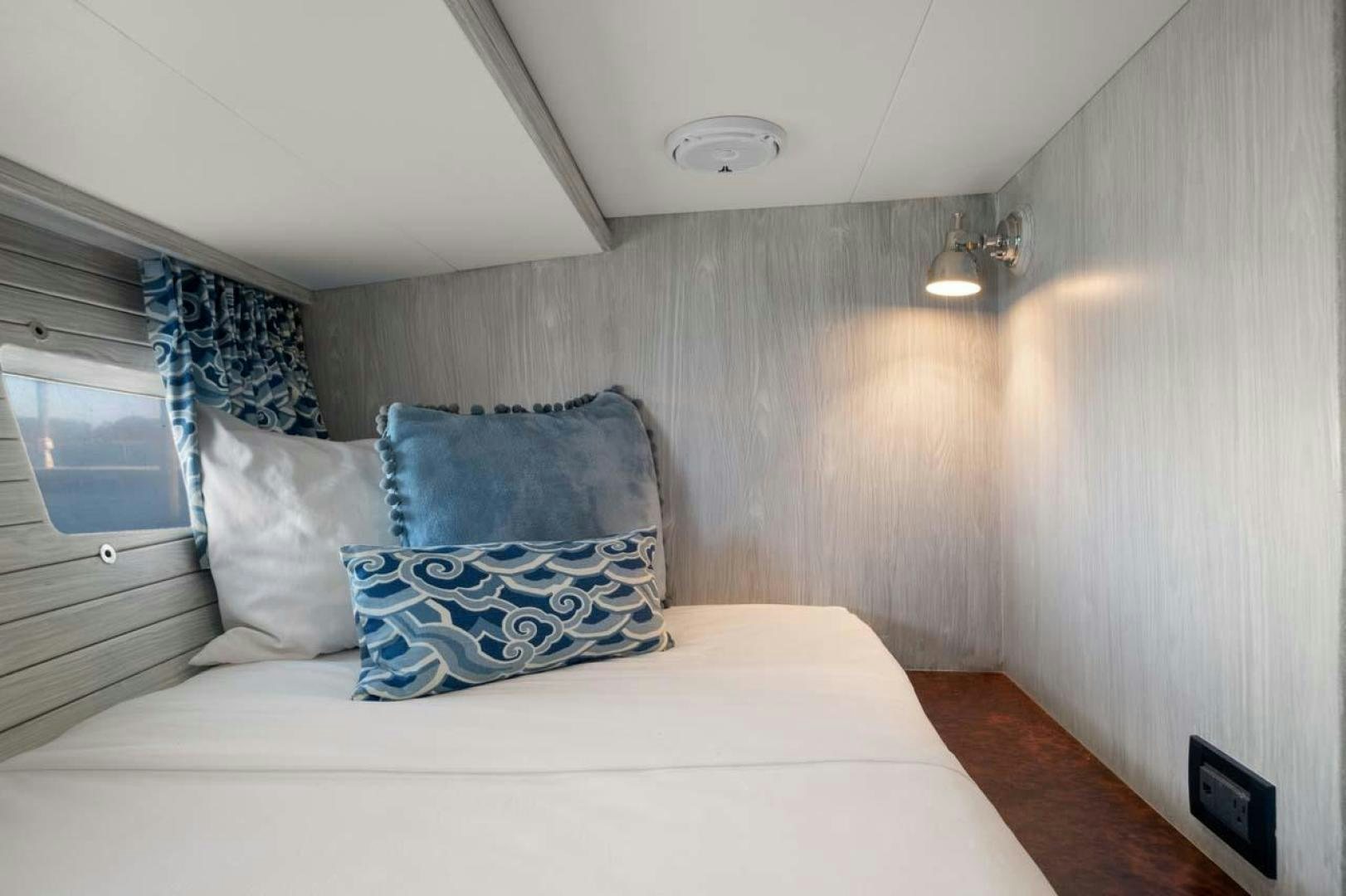 a bed with pillows aboard PIVOT Yacht for Sale
