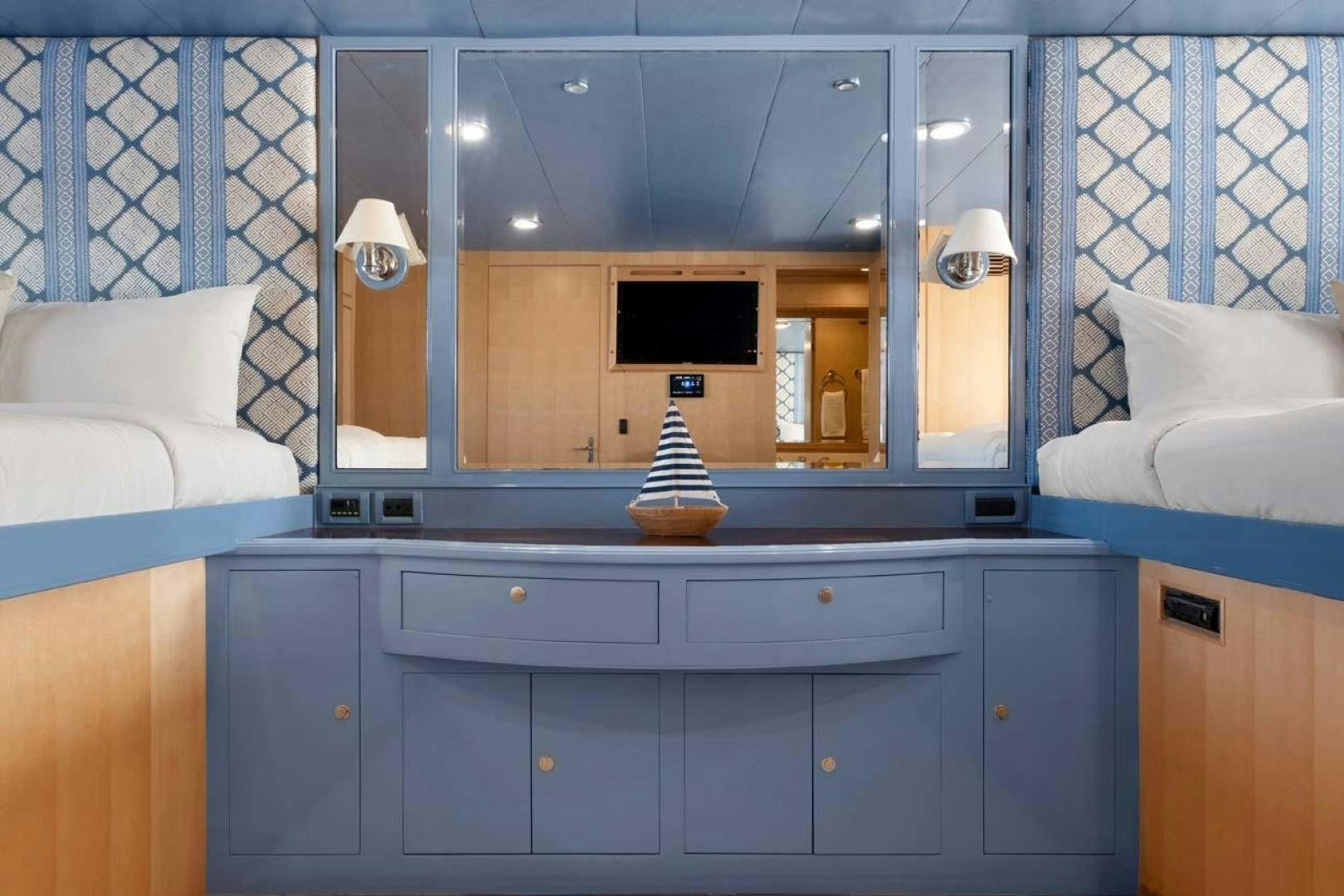 a room with a television and a bed aboard PIVOT Yacht for Sale