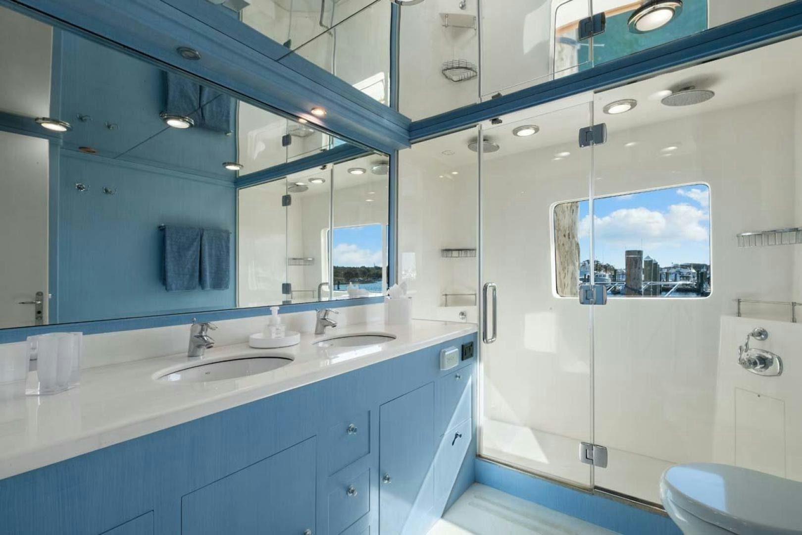 a bathroom with a large mirror aboard PIVOT Yacht for Sale
